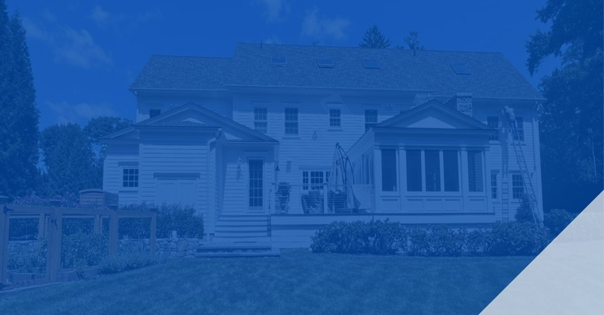 Large white house with multiple windows and a porch.