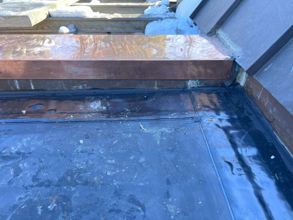 Metal flashing installed on a roof edge to prevent water intrusion.